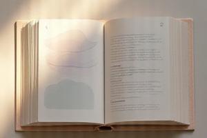 Open book with soothing sleep-themed imagery